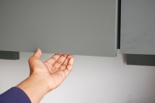 men hand open a kitchen cabinet drawer