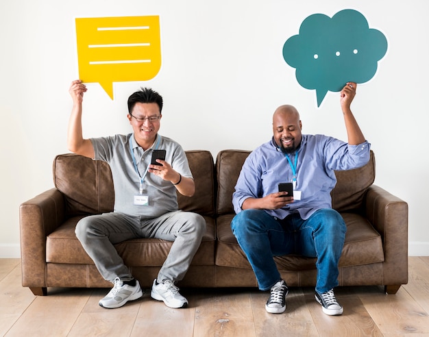 Men holding message boxes and working on mobile