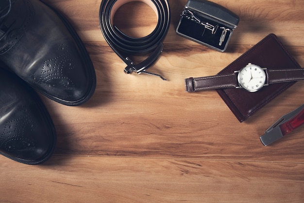 Men leather accessories on the wooden.