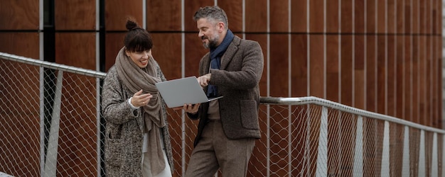 Men looking at camera while standing on mobile phone