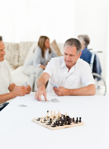 Мужчины играют в карты, пока говорят их супруги