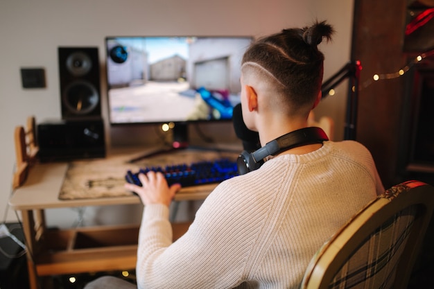 Men playing online video games at home using powerful computer streamer man using professional