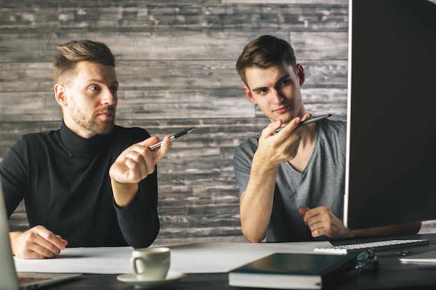 Men pointing at screen