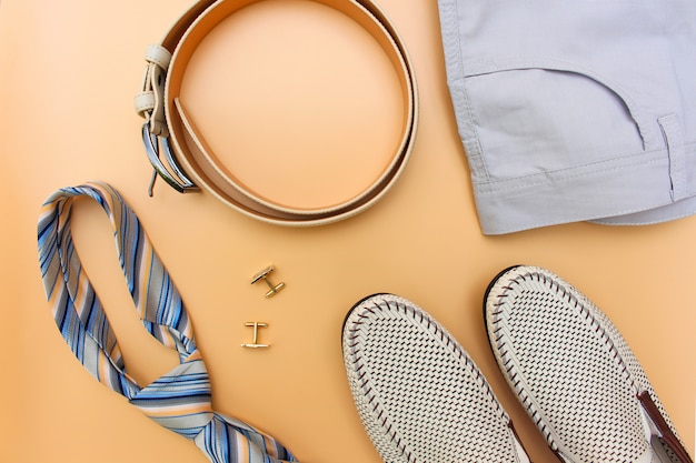 Men's accessories on beige. Top view. 