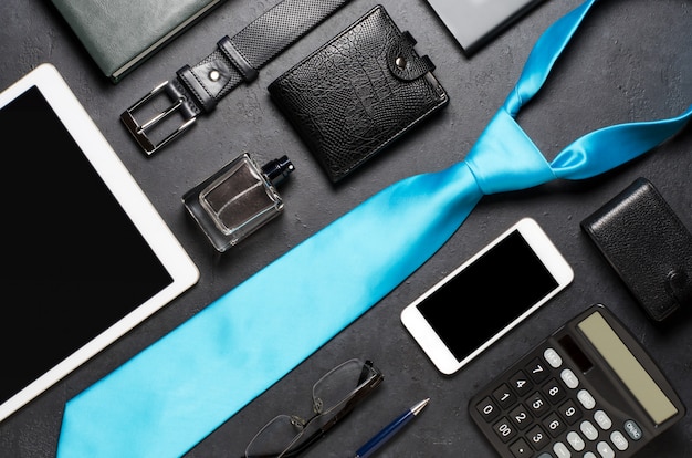 Photo men's accessories on a black concrete background. concept of a successful modern man