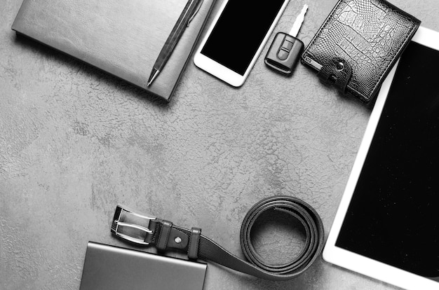 Men's accessories on a black concrete background