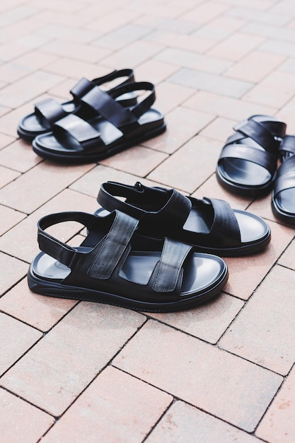 Men's black leather sandals stand on an isolated background Summer collection of men's shoes