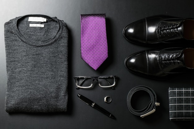 Men's business fashion outfit flatlay on dark background