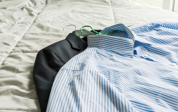 Men's classic shirts and suit on the bed