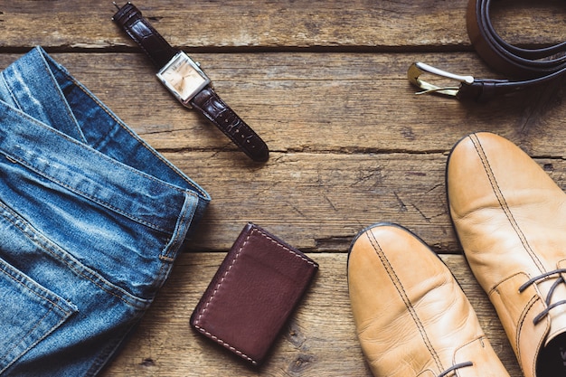 Men's clothes and accessories on wooden background. Top view