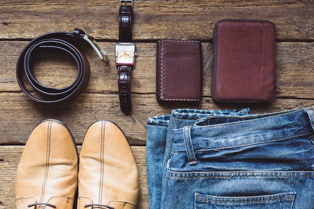 Men's clothes and accessories on wooden background. Top view