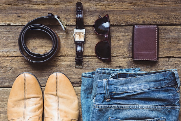 Men's clothes and accessories on wooden background. Top view