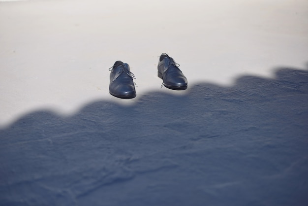 Men's dress shoes in surrealistic image, space copy