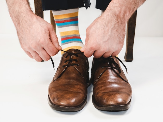 Men's feet in stylish shoes and funny socks