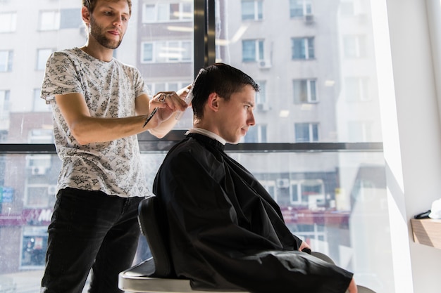 Men's hairstyling and haircutting in a barber shop or hair salon