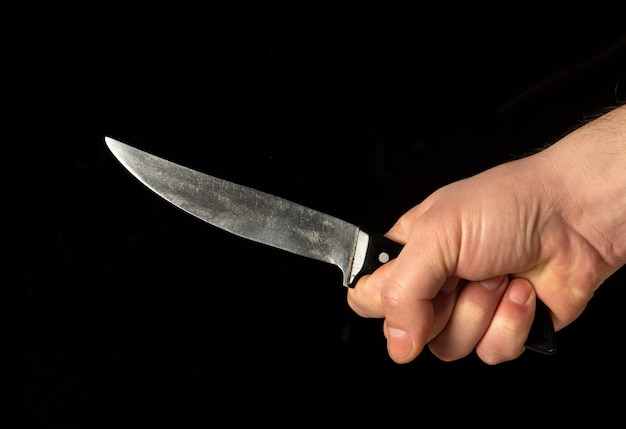 Men's hand holds sharp knife