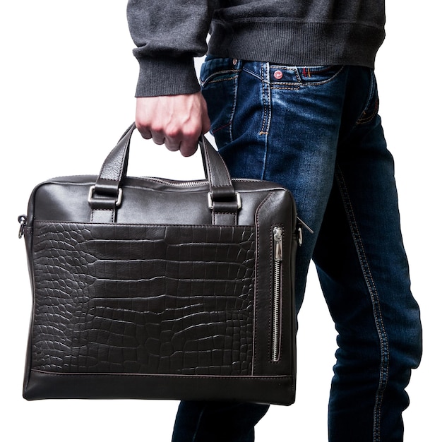 Men's hands hold a leather men's briefcase