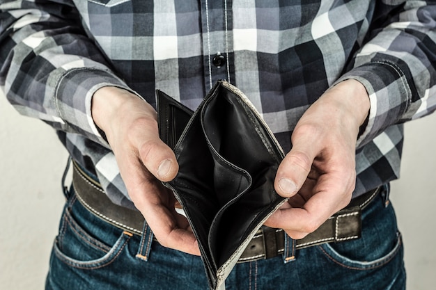 men's hands with an empty wallet. the concept of bankruptcy.