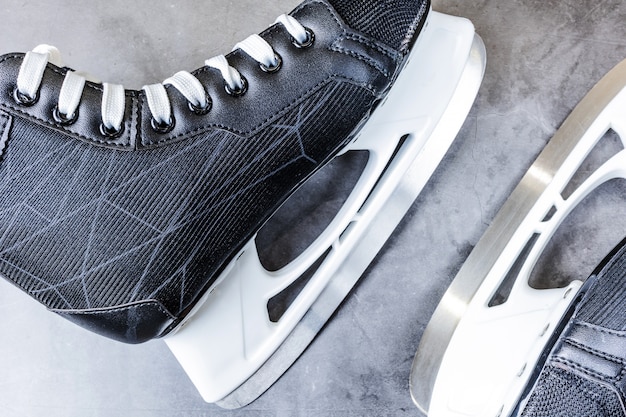 Men's hockey black and white skates on gray