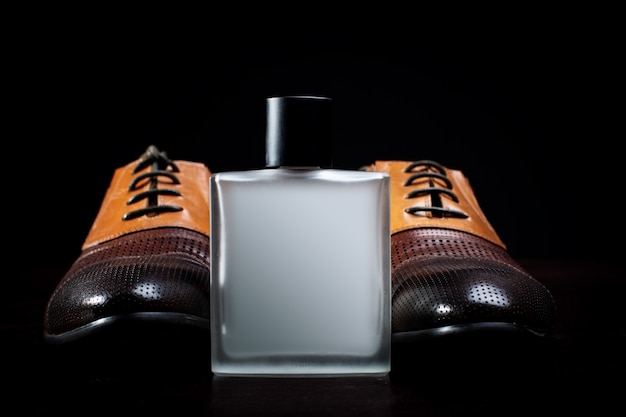 Men's leather shoes and perfume close-up