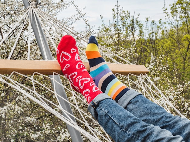 Men's legs and bright socks. Close-up, outdoor. Style, beauty and elegance concept