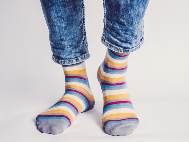 Men's legs and bright socks. Without shoes. Close-up. Style, beauty and elegance concept