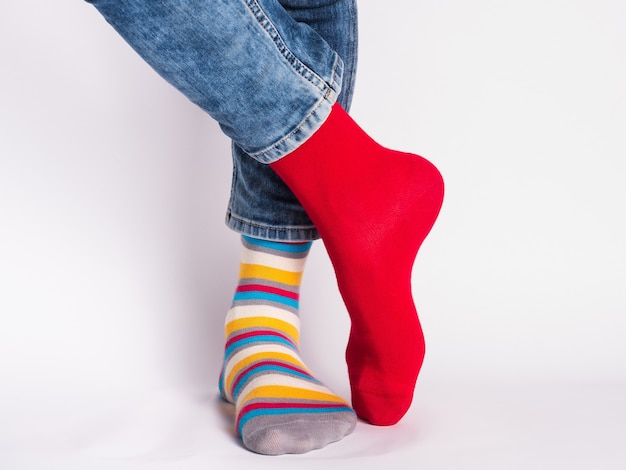 Men's legs and bright socks. Without shoes. Close-up. Style, beauty and elegance concept