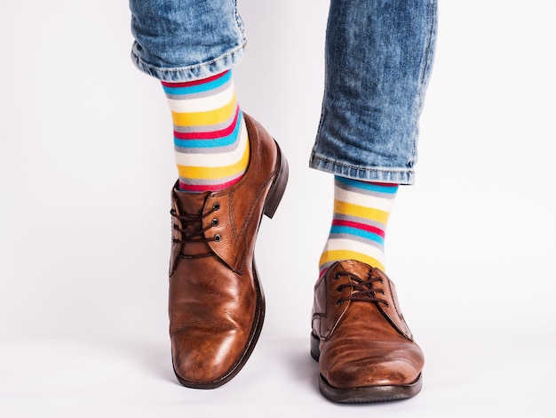 Men's legs, trendy shoes and bright socks. Close-up. Style, beauty and elegance concept