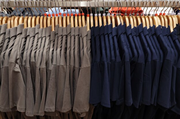 Men's polo shirts of different sizes on hangers