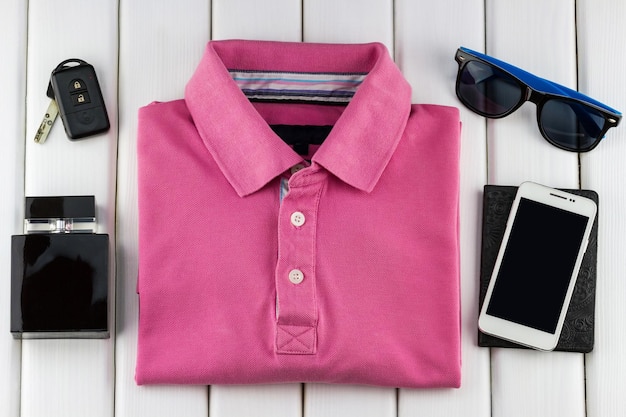 Men's set of pink t-shirt, perfume, sunglasses and smartphone