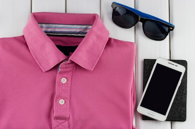 Men's set of pink t-shirt, sunglasses and smartphone