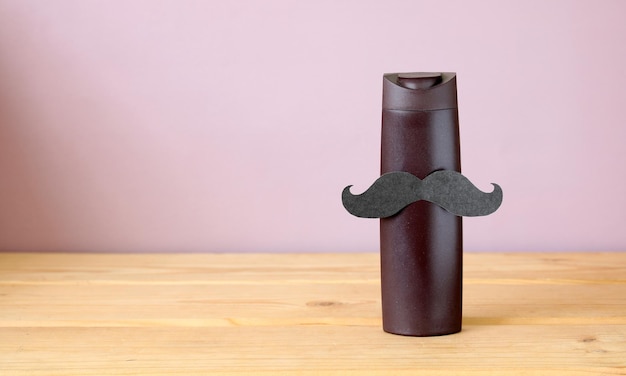 Men's shampoo or shower gel with a paper mustache