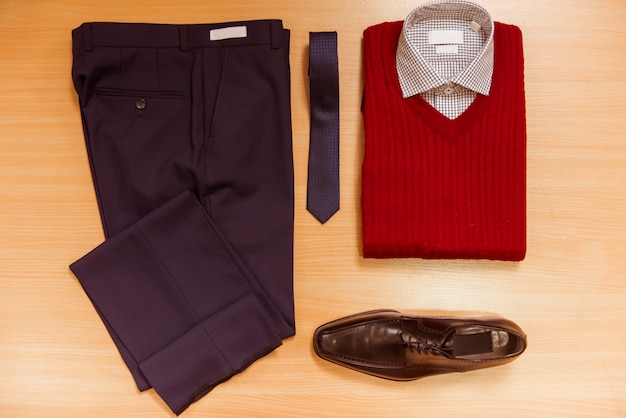 Men's shirt, sweater, trousers, tie and shoes.