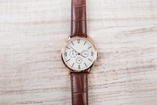 Men's watch on a wooden background View from above