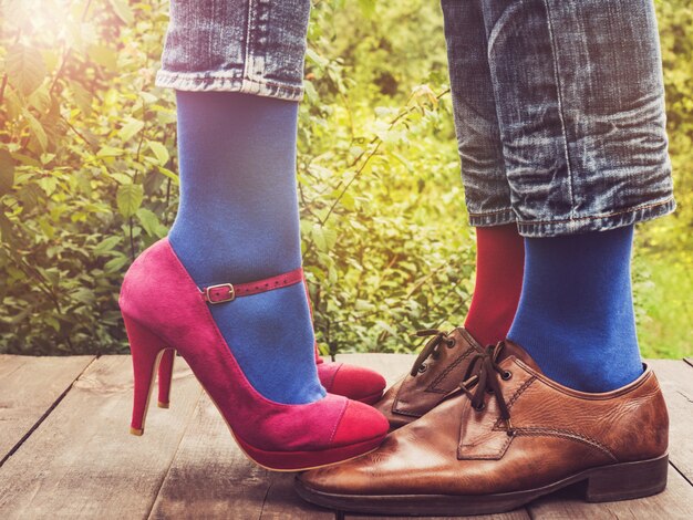 Men's and women's legs, bright socks. Close-up