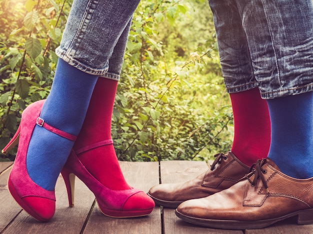 Men's and women's legs, bright socks. Close-up