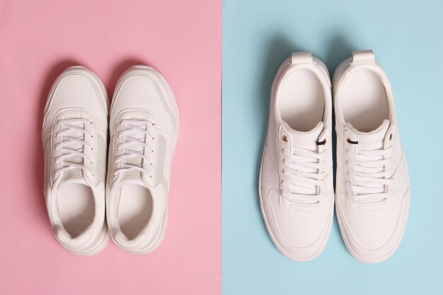 Men's and women's sneakers on a colored background top view. Sport shoes. White running shoes. High quality photo