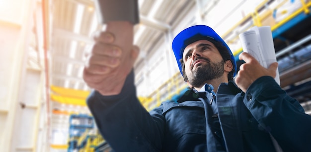 Men shaking hands in an industrial facility