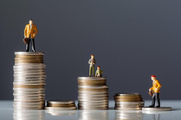 Men standing on the top of stack of coins