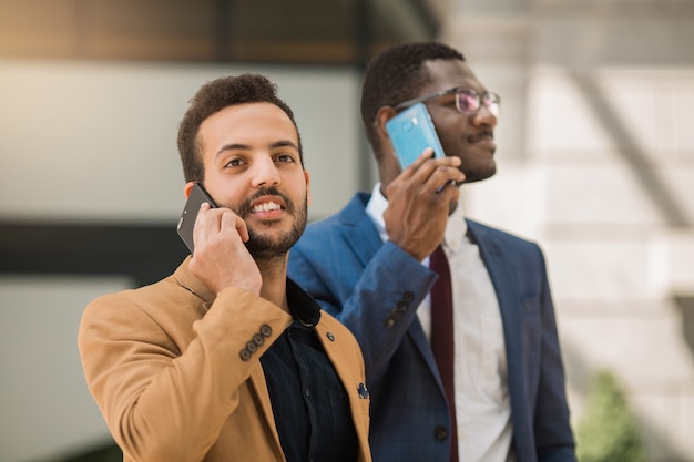 men in suits are talking on the phone