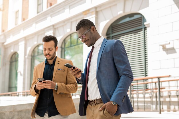 men in suits with phones in hand