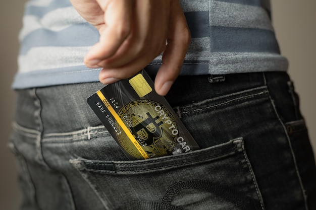 Photo men take out the crypto currency card from the jeans bag.