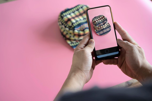 Men take photos of hats for sale online on the Internet