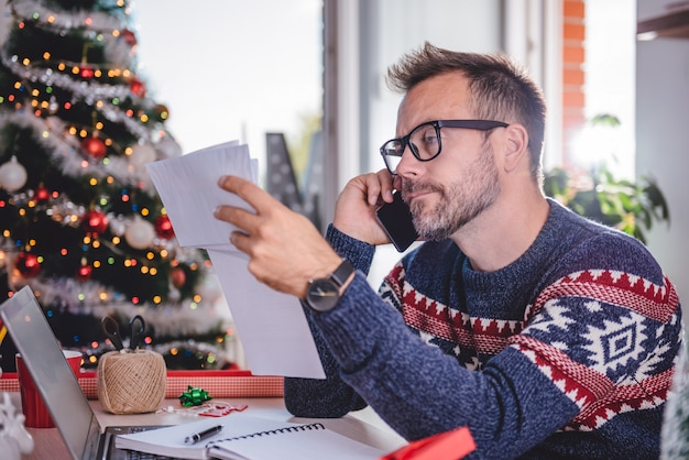 Men talking on phone and holding bills