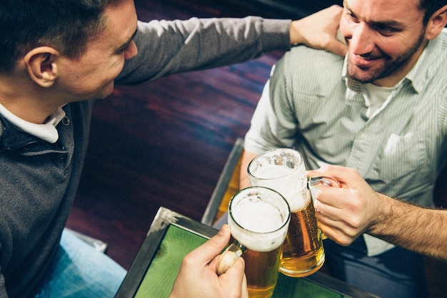 Men toasting beer glass