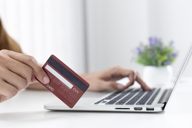 Men use laptop to register online purchases using credit card payments