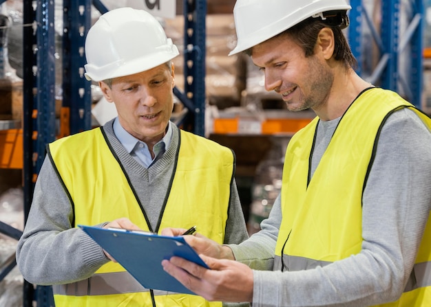 Photo men in warehouse working