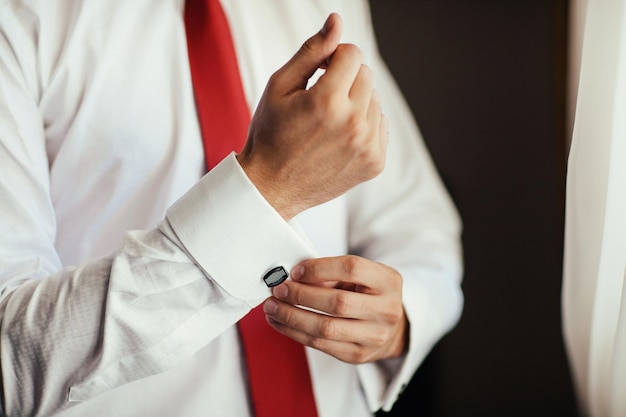 Men wear cufflinks on a shirt sleeve