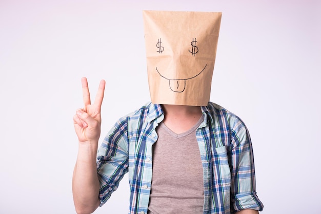 Men wearing funny paper mask showing victory and dollar symbol