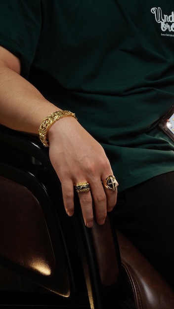 men wearing a golden bracelet on hand and rings of gold